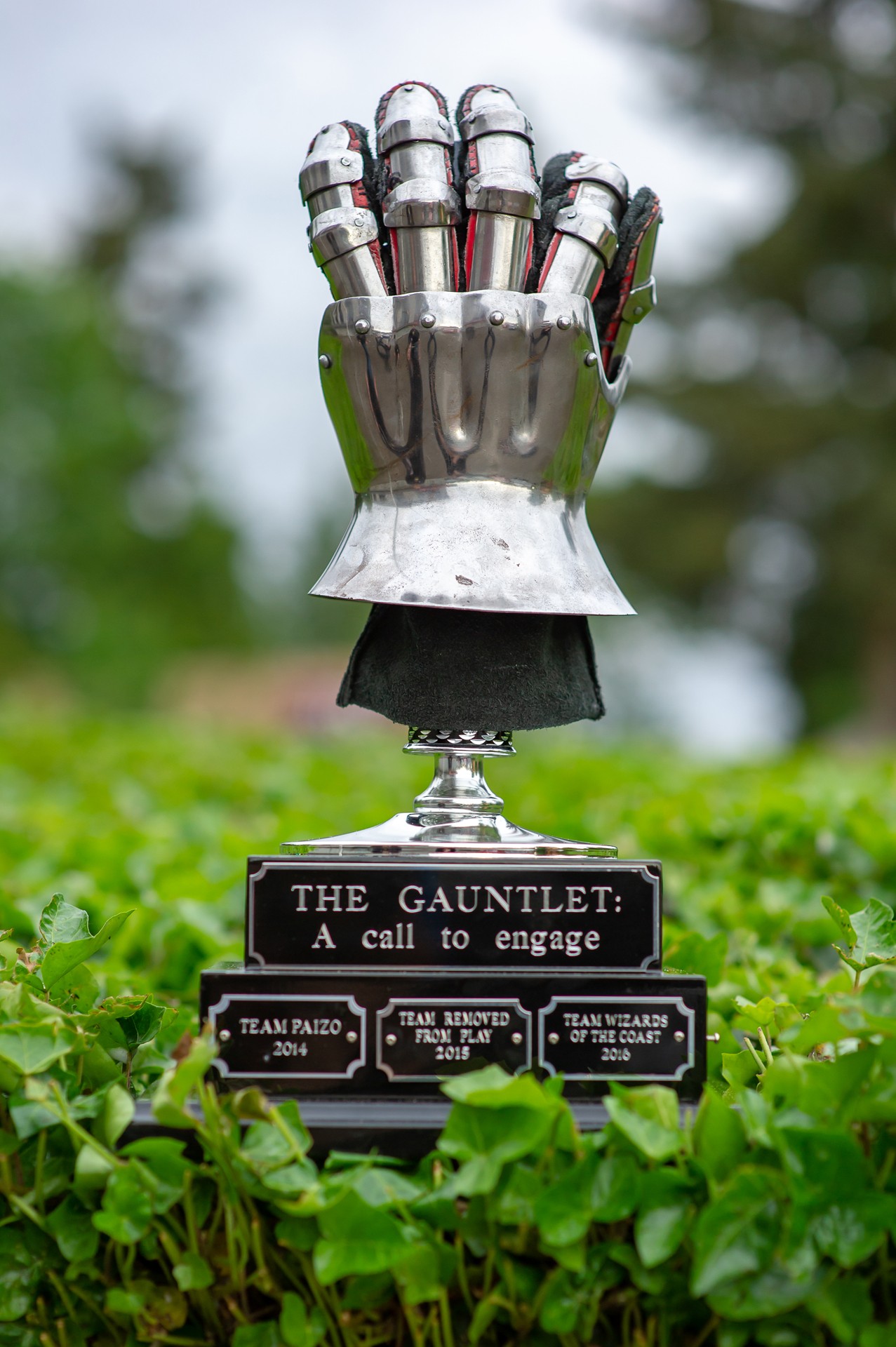 Picture of the Gauntlet trophy in a leafy background