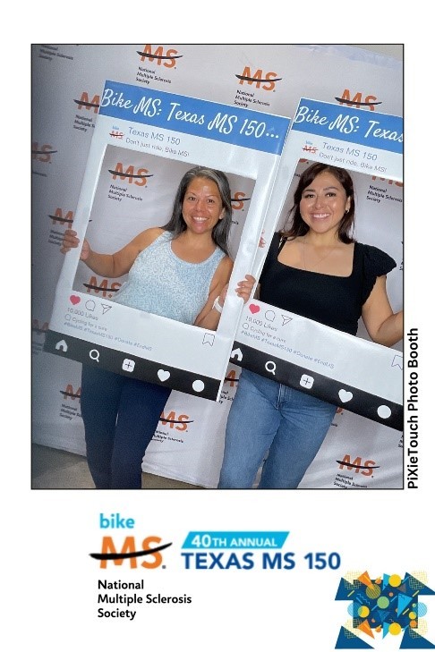 Two women pose in Bike MS photobooth