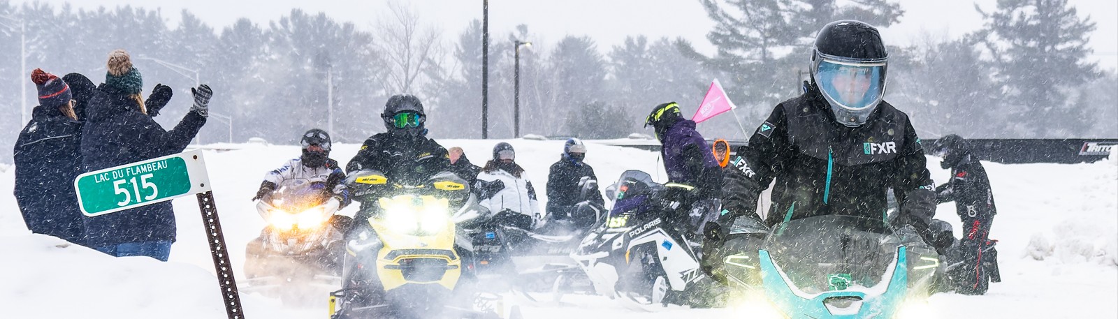 Group rides their snowmobiles on the tour