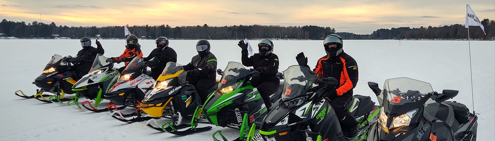 Team poses with their snowmobiles