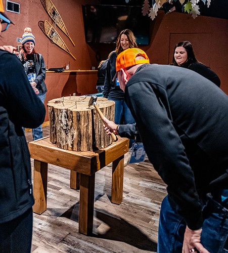 Group of participants play a hammer game