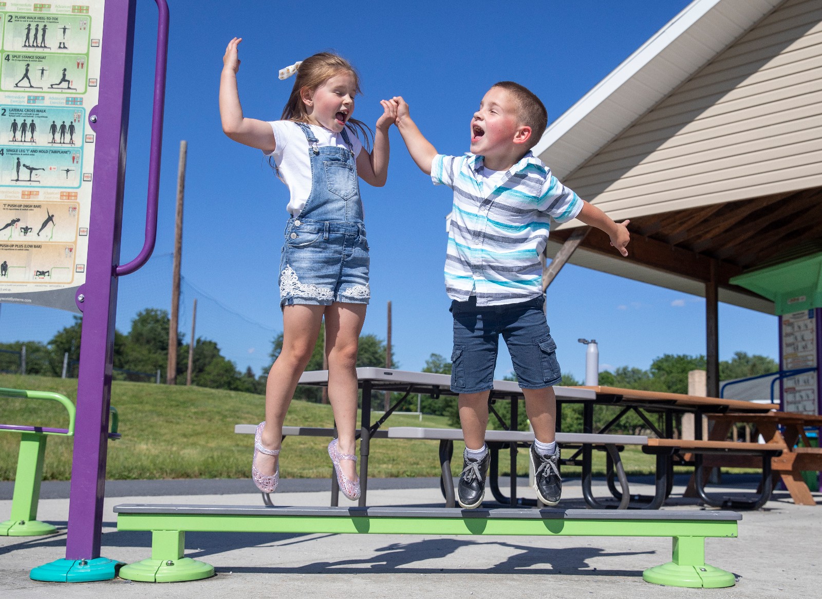 Miracle Child siblings Laken and Deacon jump joyfully off a balance beam at a playground in York