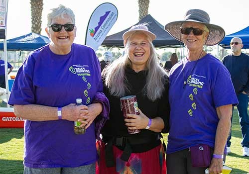 Group of three women smiling at a Walk4Hearing event in Arizona